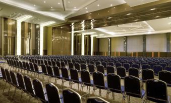 a large conference room with rows of chairs arranged in a semicircle , ready for a meeting or event at Novotel Bangka - Hotel & Convention Centre
