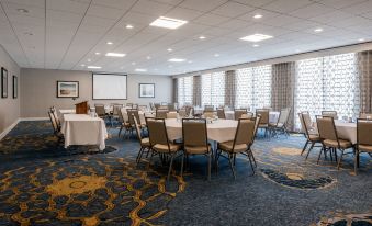 a large conference room with multiple tables and chairs , set up for an event or meeting at Holiday Inn South Kingstown (Newport Area)