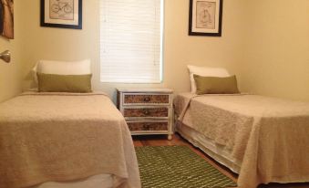 a room with two twin beds , one on the left side and the other on the right side of the room at Mountain Cove Farms Resort
