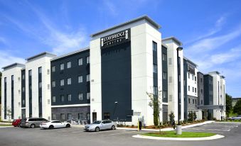 a large , modern building with a starbucks coffee sign on the side of the building at Eastwood Hall