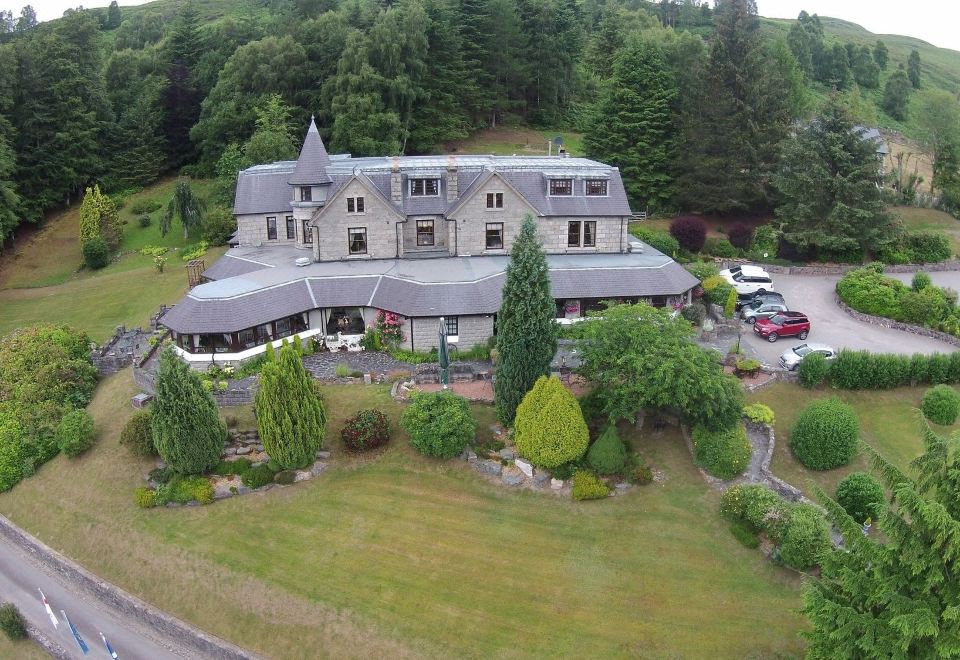 an aerial view of a large house surrounded by trees , with a driveway leading up to it at Glenspean Lodge Hotel
