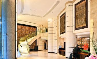 The upscale hotel features a spacious lobby adorned with elegant chandeliers and a grand staircase at Royal View Hotel