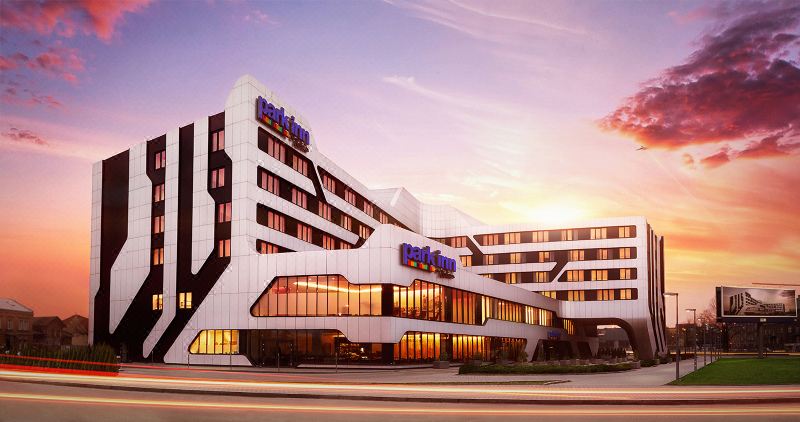 "a modern hotel building with a large sign that reads "" radisson blu "" on the front" at Park Inn by Radisson Krakow