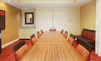 a large conference room with a long wooden table and several chairs arranged for a meeting at Residence Inn by Marriott Princeton at Carnegie Center