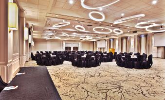 a large banquet hall with multiple tables and chairs set up for a formal event at Crowne Plaza Kitchener-Waterloo