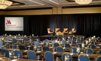 a large conference room with rows of chairs arranged in a semicircle , ready for an event at Atlanta Airport Marriott