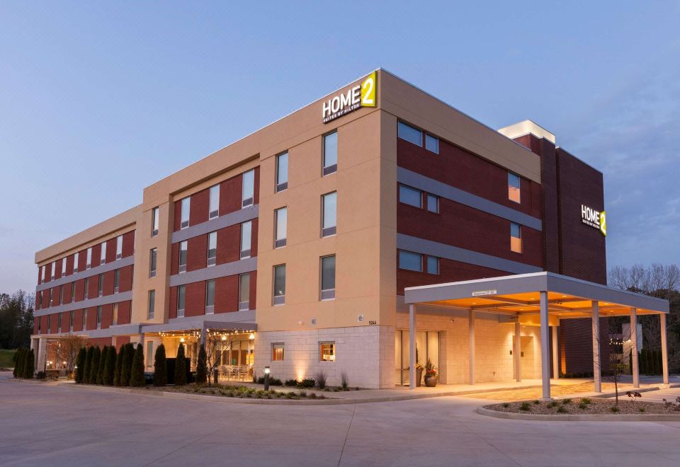 an exterior view of a home 2 suites hotel , with the hotel 's name displayed prominently at Home2 Suites by Hilton Canton