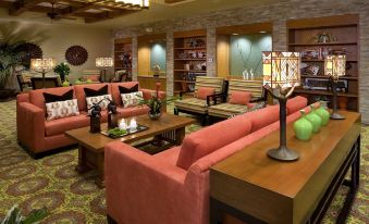 a well - lit living room with multiple couches and chairs arranged around a coffee table , creating a cozy atmosphere at Hyatt Vacation Club at the Welk, San Diego