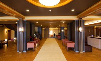 The lobby features chairs and tables in the center, as well as an entrance to another area at Fuji Ginkei