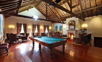 a large room with a pool table and a fireplace , creating a cozy atmosphere for games or socializing at The Vintage House - Douro