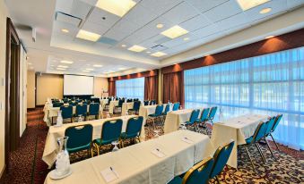a large conference room with rows of chairs arranged in a semicircle , ready for a meeting or event at Hilton Garden Inn Laramie