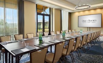 a long dining table set up for a meeting , with several chairs arranged around it at Omni Barton Creek Resort and Spa Austin