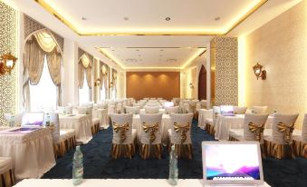 a large conference room with multiple tables and chairs arranged for a meeting or event at Alfahad Hotel