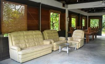 a living room with three couches , two chairs , and a coffee table in the center at Refarm