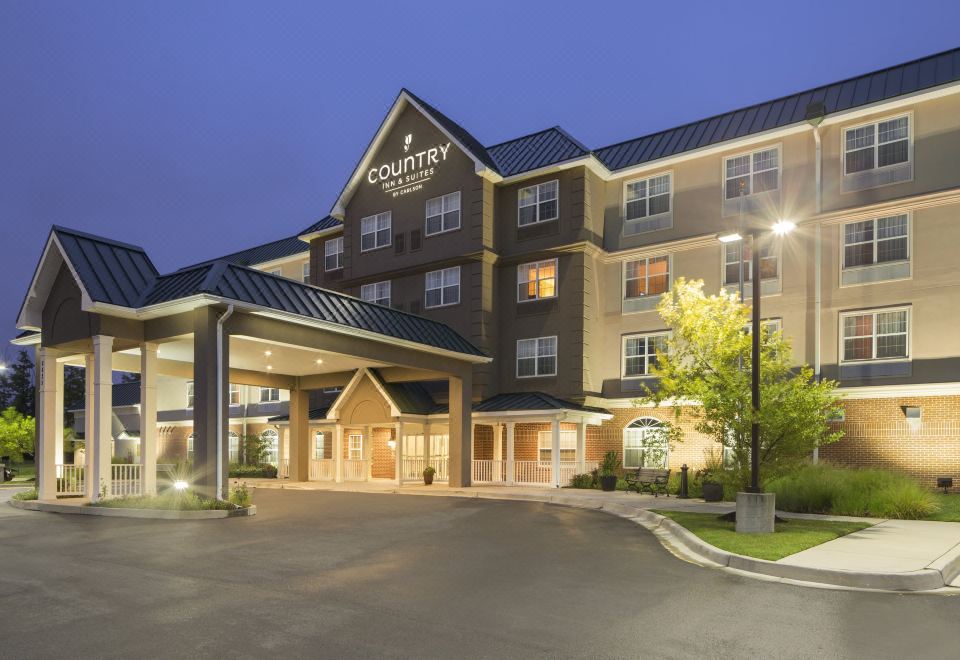"a large hotel building with a sign that reads "" country inn & suites "" prominently displayed on the front of the building" at Country Inn & Suites by Radisson, Baltimore North/White Marsh