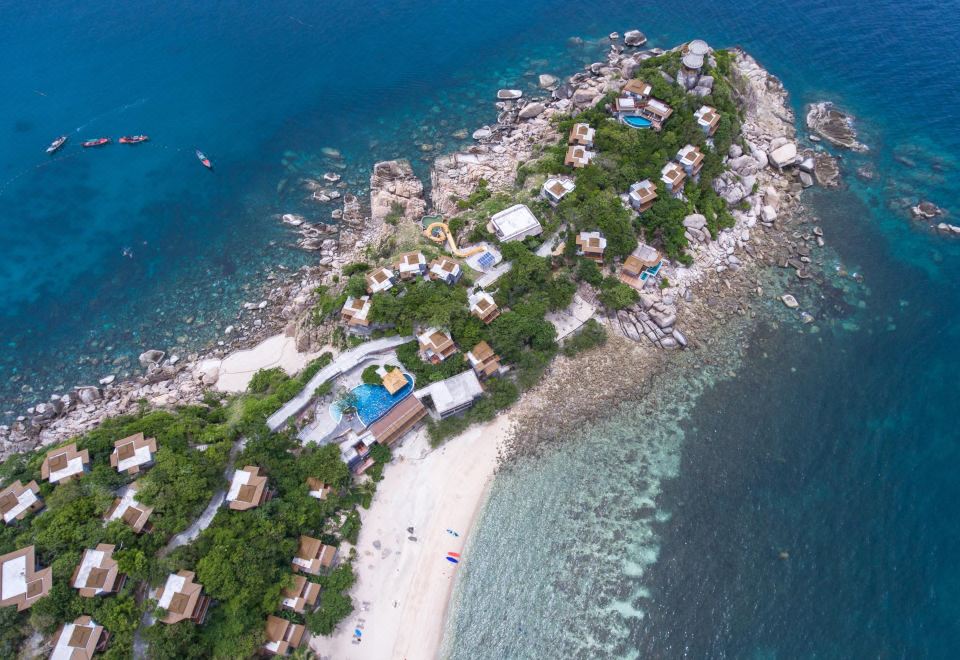 a bird 's eye view of a resort on an island surrounded by water and rocks at Sai Daeng Resort