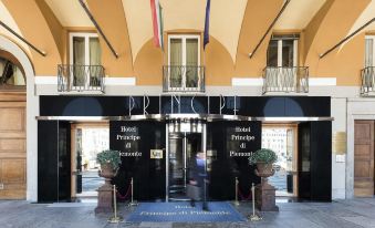 the entrance to a hotel , with two flags hanging on either side of the door at Phi Hotel Principe