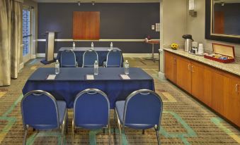 a conference room set up for a meeting , with several chairs arranged in a semicircle around a table at Residence Inn Waldorf