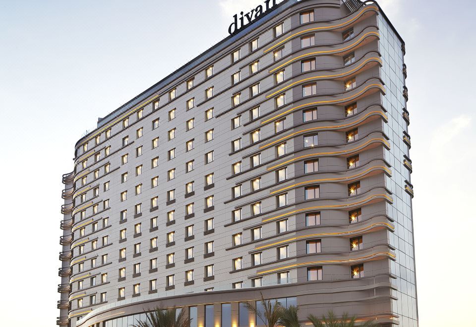 "a large hotel building with many floors and a sign that says "" dünn "" on the top" at Divan Mersin