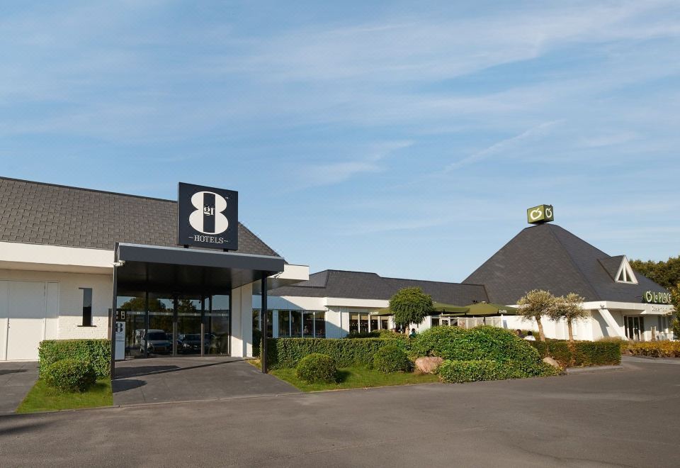 "a large hotel building with a sign that says "" b "" on the front , surrounded by a parking lot" at Gr8 Hotel Sevenum