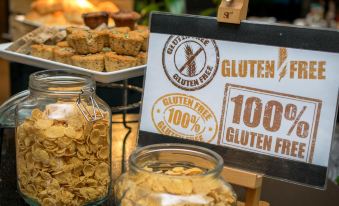 a display of 1 0 0 % gluten free food items at a market , with a sign indicating the product 's 1 0 0 % gluten at Le Meridien Chiang Rai Resort, Thailand