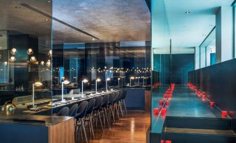 The restaurant is illuminated by overhead lighting and features tables and chairs along the wall at the Westin Xi'an
