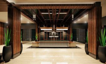 a modern hotel lobby with a reception desk , potted plants , and a large mirror on the wall at Hotel Neo Eltari - Kupang by Aston