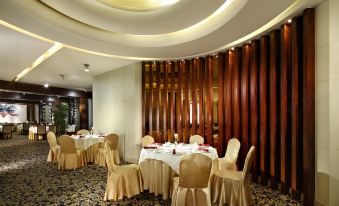 A room is available for events or formal dining, equipped with tables and chairs in the center at Dong Fang Hotel