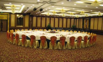 A spacious room is arranged with tables and chairs for hosting events or functions at President Hotel (Guangzhou Tianhe Gangding Subway Station Store)