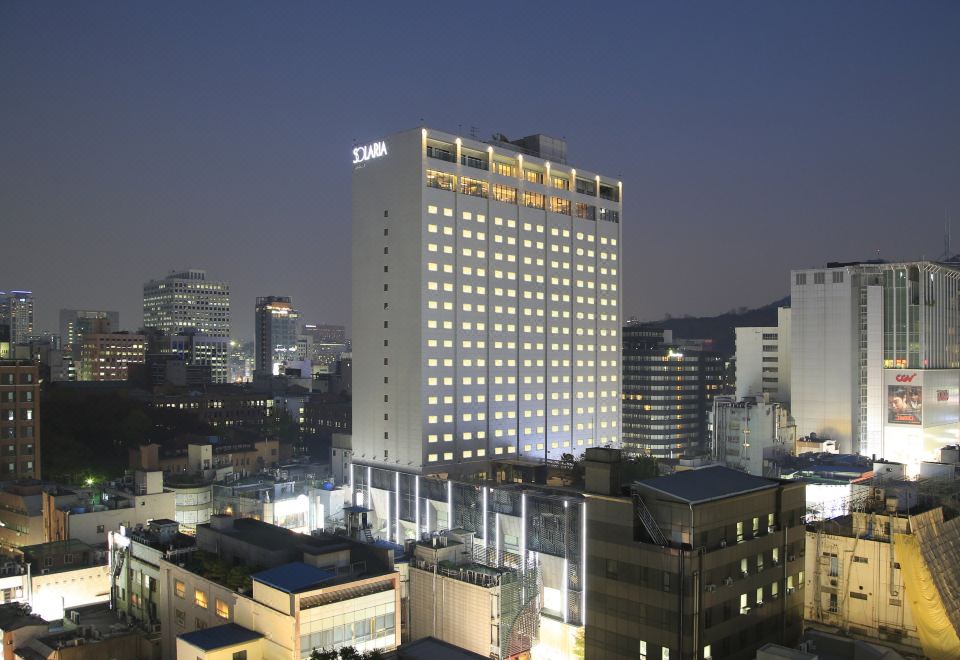The ground floor offers a stunning nighttime view, featuring an illuminated building in the foreground and the cityscape in the background at Solaria Nishitetsu Hotel Seoul Myeongdong