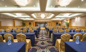 A spacious room is arranged with blue chairs and tables for an event at the hotel at Park Inn by Radisson Shanghai Downtown