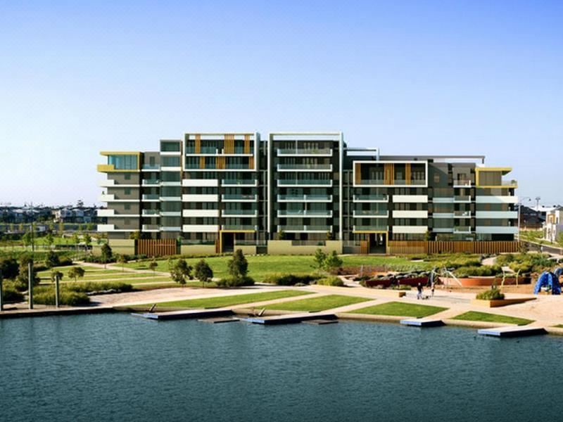 a large apartment building situated near a body of water , possibly a lake or a river at Mercure Melbourne Caroline Springs