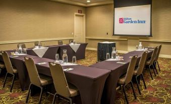 a conference room set up for a meeting , with chairs arranged in a semicircle around a table at Hilton Garden Inn Boise/Eagle