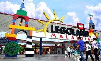 a group of people standing in front of a large building , possibly a shopping mall , with the entrance decorated in lego style at Hallmark Regency Hotel - Johor Bahru