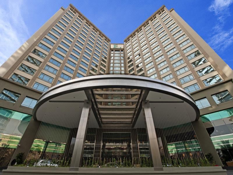 There is a large building with a main entrance and additional buildings in front at Eastin Hotel Kuala Lumpur
