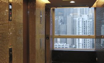 a spacious second-floor room with an elevator and windows at Ramada Hong Kong Harbour View