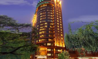 The building where the hotel is located is illuminated by street lamps at night at Merchant Marco Hotel