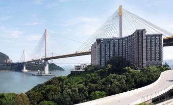 A large bridge extends across the width and connects to other tall buildings on both sides at Royal View Hotel