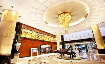 The entrance of a grand building features chandeliers on both sides, creating an elegant ambiance at Dong Fang Hotel