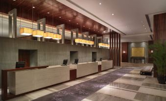 The hotel lobby is modern and spacious, providing ample space for various activities at Hyatt Regency Hong Kong, Tsim Sha Tsui