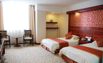 The room is spacious with two beds and an open doorway leading to the other side at Yuhang Hotel